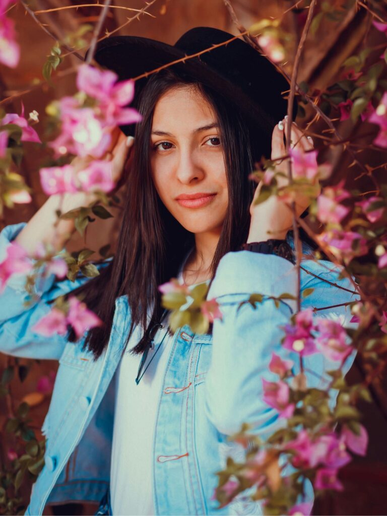 Trendy spring outfit combination with floral midi dress, denim jacket and white sneakers - versatile look for college students and young professionals.