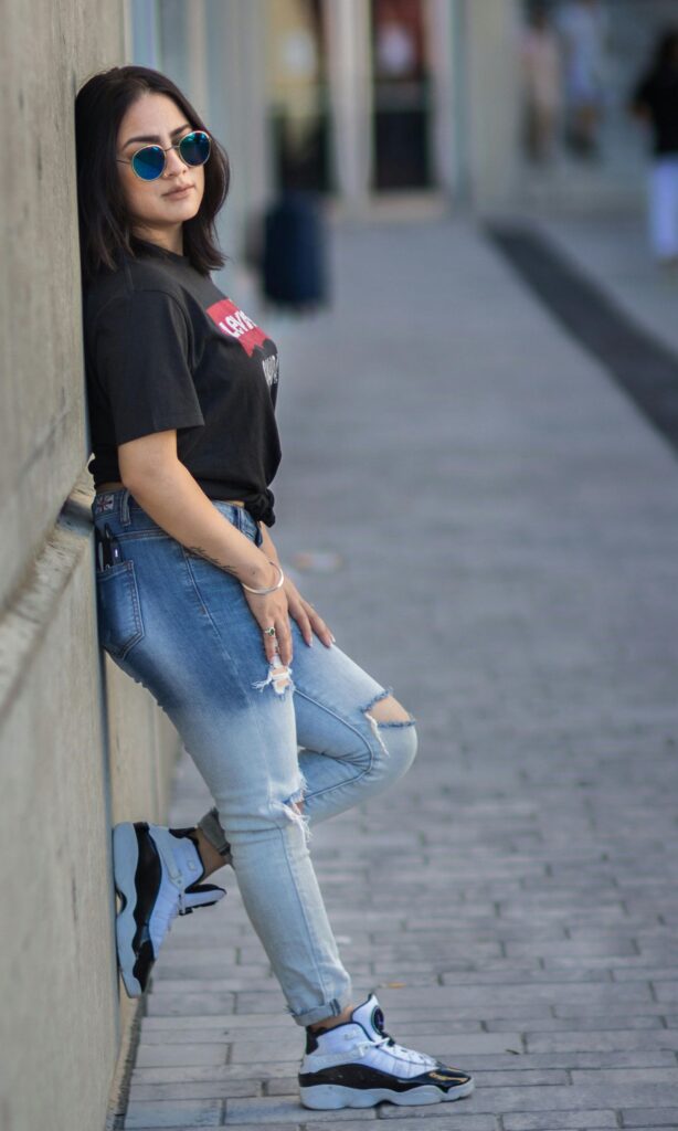 Trendy spring outfit combination with floral midi dress, denim jacket and white sneakers - versatile look for college students and young professionals.